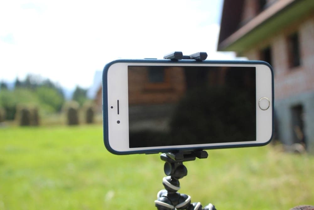 A phone on a small tripod, set up to film