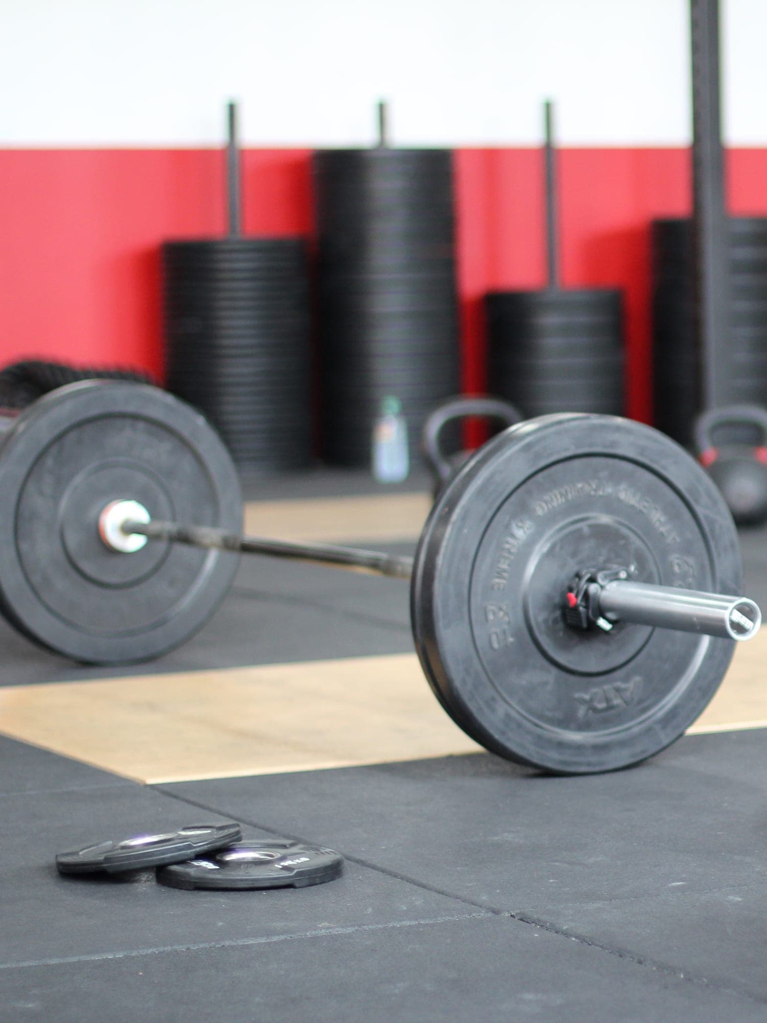 A loaded barbell on a gym floor